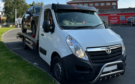 A towing truck with a loaded car.